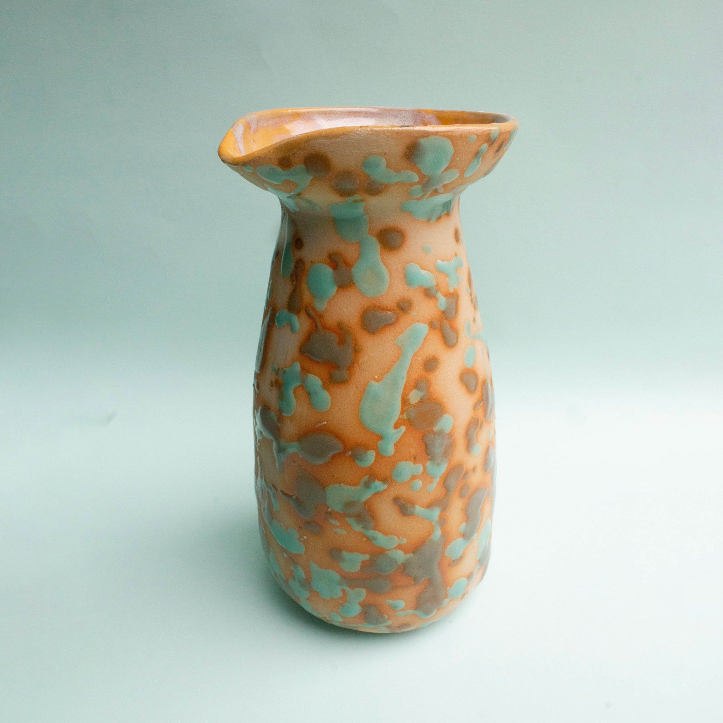 Handgefertigter caramell und türkisfarbener Krug inspiriert von peruanischen präkolumbischen Formen.