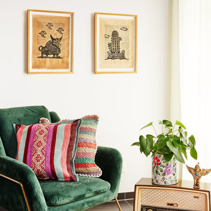 grüner Sessel mit Kissen, Blumentopf und Bilder im Hintergrund